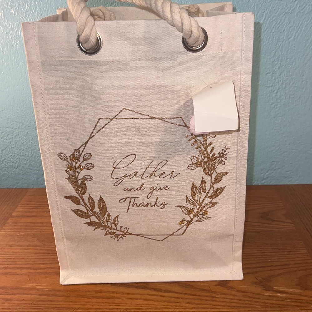 Cream colored canvas reusable bag, “Gather and give Thanks” written on side NWT